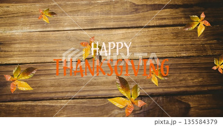 Image of happy thanksgiving text over autumn leaves on wooden boards Image of happy thanksgiving text over autumn leaves on wooden boards 135584379