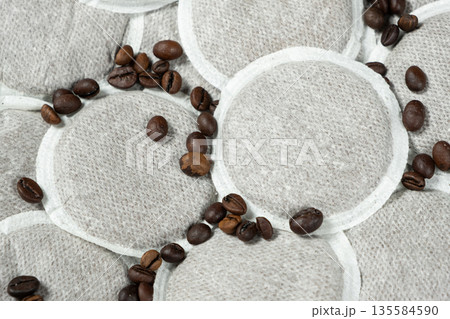 Coffee pads for brewing coffee in the coffee machine and scattering coffee beans Coffee pads for brewing coffee in the coffee machine and scattering coffee beans 135584590