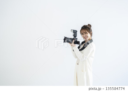 デジタルカメラを持つ女性 135584774