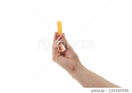 Adult man hand hold dry rigatoni pasta isolated on whit background Adult man hand hold dry rigatoni pasta isolated on whit background 135585836