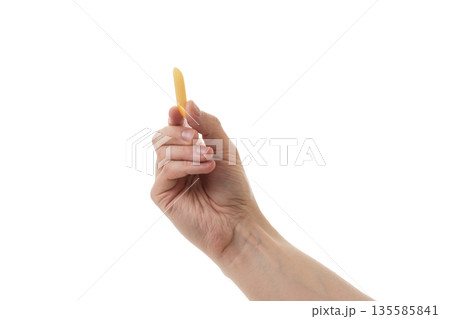 Adult man hand hold dry penne rigate pasta isolated on whit background Adult man hand hold dry penne rigate pasta isolated on whit background 135585841