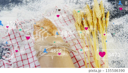 Shaping floured baker's hand pressing whole grain loaf on checkered towel, parchment, social icons Shaping floured baker's hand pressing whole grain loaf on checkered towel, parchment, social icons 135586390