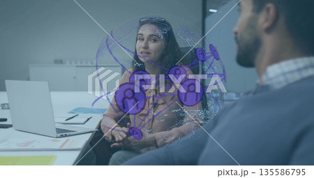 Two coworkers discussing digital network hologram in office meeting room, with laptop and notebook Two coworkers discussing digital network hologram in office meeting room, with laptop and notebook 135586795