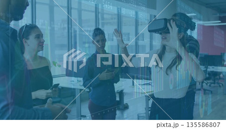 Interacting woman wearing VR headset testing projected interface in office, with phones, copy space Interacting woman wearing VR headset testing projected interface in office, with phones, copy space 135586807