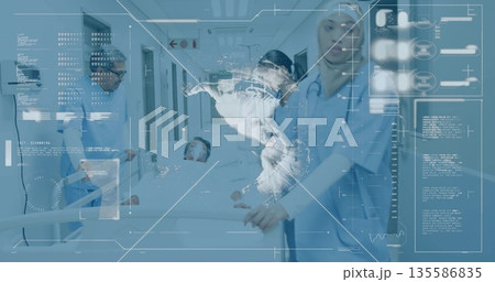 Attending medical team pushing stretcher down hospital corridor, with digital map and stethoscopes 135586835