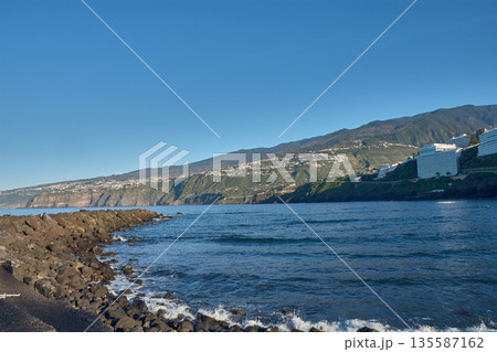 The Atlantic Ocean with gentle waves in front of the line of hotels and apartments in Puerto de la Cruz, northern Tenerife 135587162