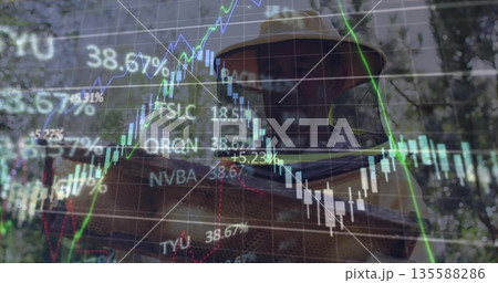 Inspecting beekeeper wearing beekeeping suit holding bee-covered frame in apiary, with stock charts 135588286