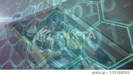 Displaying open wooden toolbox on bench with assorted hand tools, hex and binary digits overlay Displaying open wooden toolbox on bench with assorted hand tools, hex and binary digits overlay 135588585
