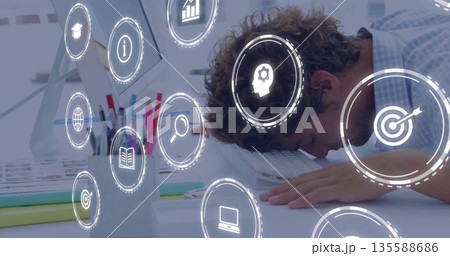 Leaning office worker resting head on keyboard by monitor at desk with floating icons, copy space 135588686