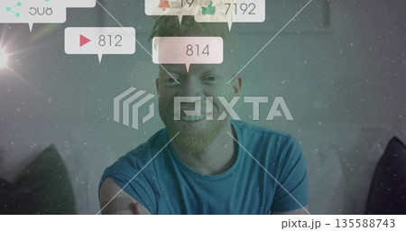 Smiling streamer broadcasting from sofa at home, with digital notification bubbles showing counts Smiling streamer broadcasting from sofa at home, with digital notification bubbles showing counts 135588743