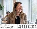 Cheerful Professional Woman Laughing in Office 135588855