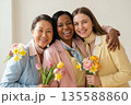 Joyful Diverse Women Celebrating Spring with Fresh Flower Bouquets 135588860