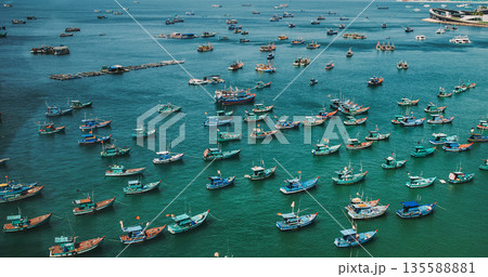 Fishing boats, coastal harbor, turquoise water, aerial view 135588881