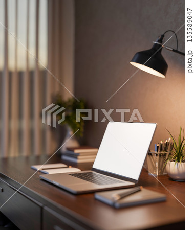 Bank screen laptop with books and pencil under lamp light in a dim lit living room or bedroom. Bank screen laptop with books and pencil under lamp light in a dim lit living room or bedroom. 135589047