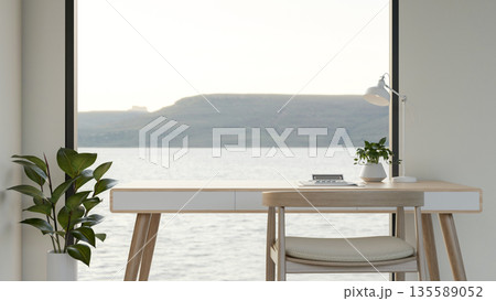 Calculator and pot plant aside lamp on wooden table with outside scenery through glass window wall. Calculator and pot plant aside lamp on wooden table with outside scenery through glass window wall. 135589052