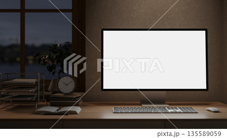 White screen computer and clock atop books on wooden table under window in a dim lit room. White screen computer and clock atop books on wooden table under window in a dim lit room. 135589059