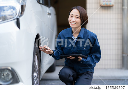 車の修理をするミドルの女性の自動車整備士 135589207