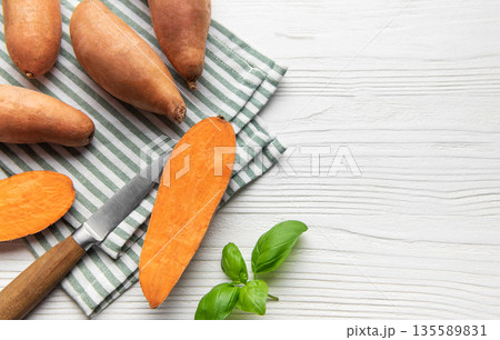 Sweet potato preparation with basil on striped napkin Sweet potato preparation with basil on striped napkin 135589831