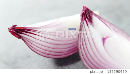 Showcasing close-up of two red onion halves on kitchen countertop, showing vibrant purple rings Showcasing close-up of two red onion halves on kitchen countertop, showing vibrant purple rings 135590459