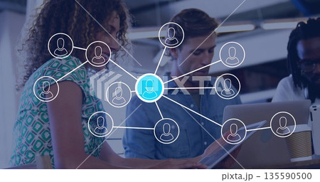 Collaborating team viewing network diagram in office, with tablet laptop, coffee cup Collaborating team viewing network diagram in office, with tablet laptop, coffee cup 135590500