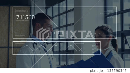 Reviewing clinician holding blue folder facing physician in corridor, with holograms 135590545