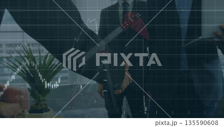 Professionals wearing suits discussing energy market in office, pump jack model and laptop Professionals wearing suits discussing energy market in office, pump jack model and laptop 135590608