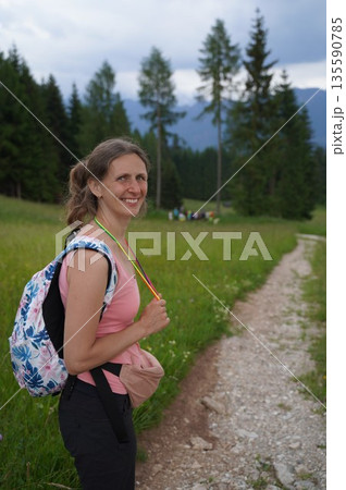 Woman Hiker Smiling on Mountain Path 135590785