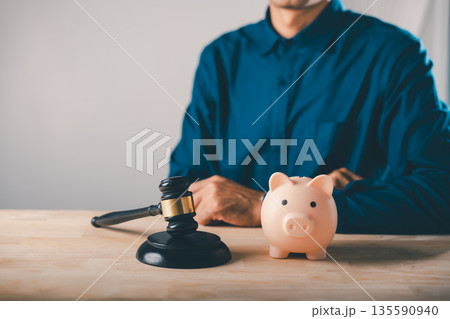 Money bank piggy salary services finance pig assessment capital risk tax legal expert manages corporate wealth and savings through judge gavel on wooden desk office table 135590940
