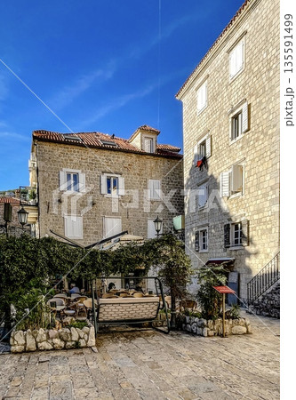 sundrenched mediterranean square lined with weathered buildings and cozy cafes for relaxation sundrenched mediterranean square lined with weathered buildings and cozy cafes for relaxation 135591499