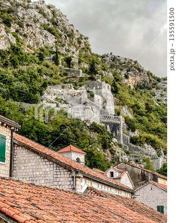 The Historic Ruins Are Located on a Beautiful Hillside Overlooking Traditional Rooftops Nearby 135591500