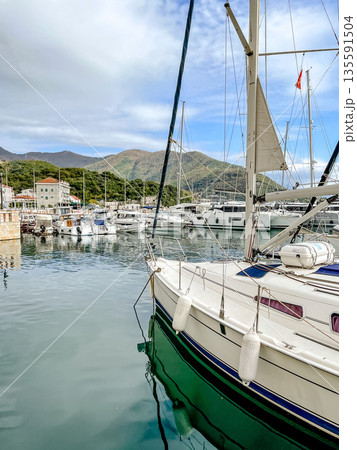 marina boat with mountains backdrop, vivid image of vessel moored against mountain scenery marina boat with mountains backdrop, vivid image of vessel moored against mountain scenery 135591504
