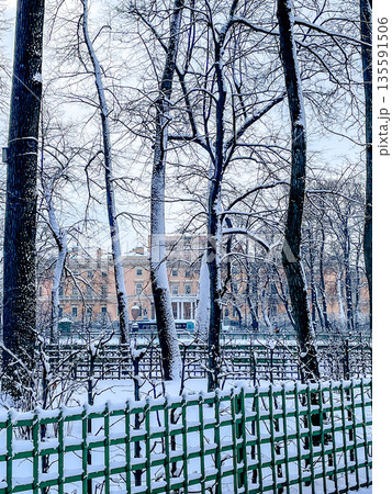 A Beautiful Snowy Winter Scene Depicting Trees and a Charming Fence in an Urban Environment A Beautiful Snowy Winter Scene Depicting Trees and a Charming Fence in an Urban Environment 135591506