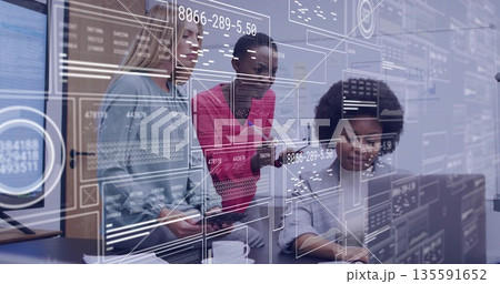 Working three women in blazers analyzing data on monitors and tablet at office desk, with overlays 135591652