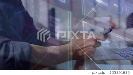 Analyzing digital overlays on laptop and holding smartphone, worker wearing shirt in modern office Analyzing digital overlays on laptop and holding smartphone, worker wearing shirt in modern office 135591659