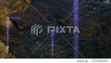 Pointing digital arrows rising over wet pebbles at rocky shoreline, numeric labels 135592007