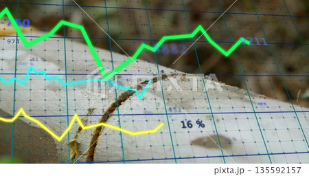Tree trunk cross-section featuring growth rings and crack in forest, with blue grid and data charts 135592157