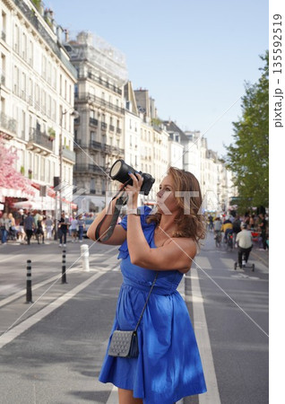Woman Photographing City Scene with Camera 135592519