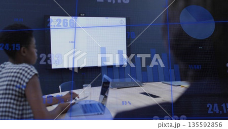Woman taking notes and analyzing charts on screen at meeting table with laptop notepad, copy space Woman taking notes and analyzing charts on screen at meeting table with laptop notepad, copy space 135592856