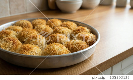 Freshly Baked Mini Kadayif Pastries In Round Baking Pan Freshly Baked Mini Kadayif Pastries In Round Baking Pan 135593125
