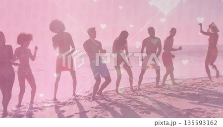 Dancing eight friends wearing swimwear celebrating on sandy shore at sunrise, with heart overlays Dancing eight friends wearing swimwear celebrating on sandy shore at sunrise, with heart overlays 135593162