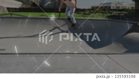 Riding skateboarder carving along bowl lip at skatepark bowl, with skateboard and suburban houses Riding skateboarder carving along bowl lip at skatepark bowl, with skateboard and suburban houses 135593198