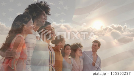Standing eight friends wearing summer wear under clouds and sun rays, with translucent USA flag Standing eight friends wearing summer wear under clouds and sun rays, with translucent USA flag 135593257