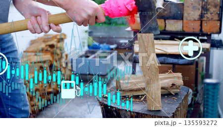 Splitting adult in pants applying axe to log on chopping block in yard, showing data overlays Splitting adult in pants applying axe to log on chopping block in yard, showing data overlays 135593272