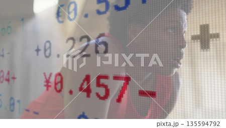 Kneeling woman in red sportswear in studio by colored screen showing euro yen rates, copy space 135594792