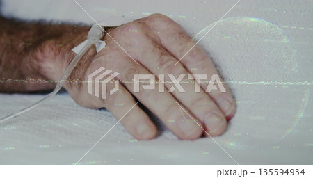 Showing senior male hand resting on white sheet in hospital room, with taped IV catheter Showing senior male hand resting on white sheet in hospital room, with taped IV catheter 135594934