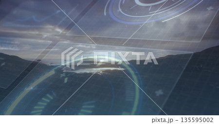 Displaying futuristic HUD overlaying coastal hillside at sunset, with circular gauges 135595002