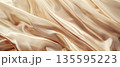 Soft champagne silk fabric folds background 135595223