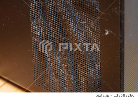 Dusty fan grille of an office computer close up Dusty fan grille of an office computer close up 135595260