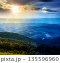 mountain landscape with rolling hills. day and night time change concept. summer countryside scenery with view in to valley and forested slopes with sun and moon. duality and transition template 135596960