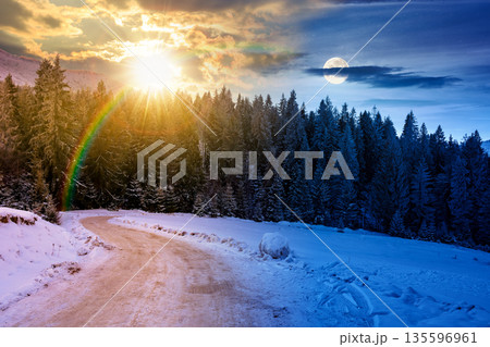 winter solstice landscape with snow covered country road winding through forest in mountains. day and night time change concept. alpine countryside with sun and moon. duality and transition template winter solstice landscape with snow covered country road winding through forest in mountains. day and night time change concept. alpine countryside with sun and moon. duality and transition template 135596961